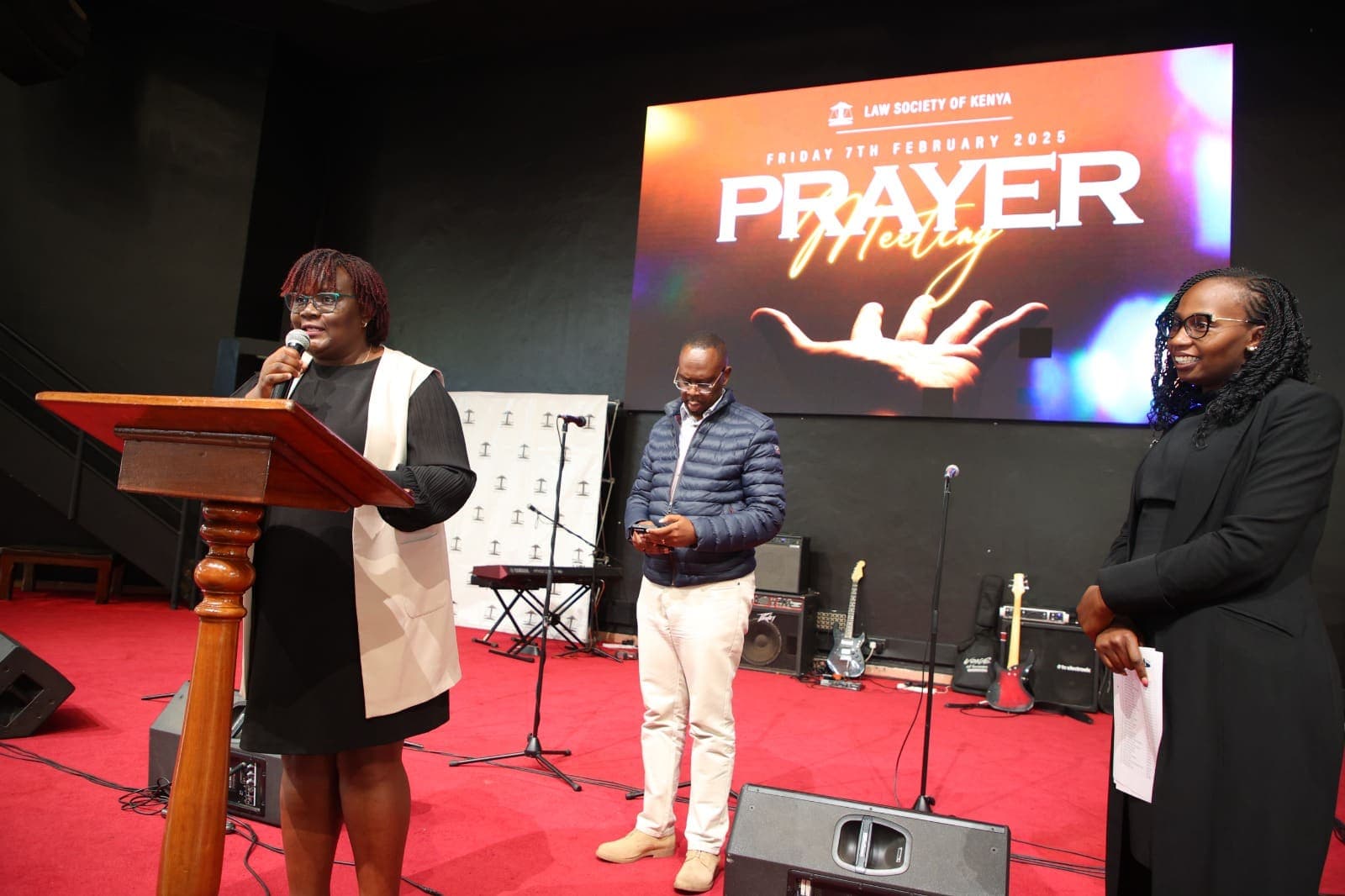 Jacqueline Ingutiah speaking at a lectern at the LSK Prayer Meeting