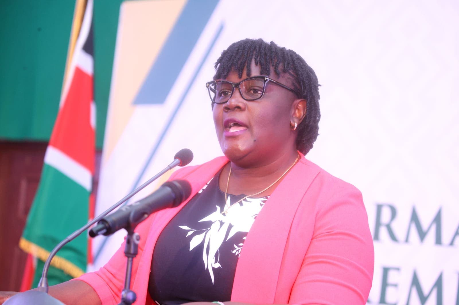 Jacqueline Ingutiah speaking at a podium at the Judiciary performance report launch